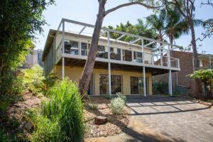 an exterior view of a house with a balcony at The Treehouse Vincentia in Vincentia