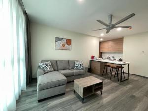 a living room with a couch and a table at Hotel Bundusan in Kota Kinabalu