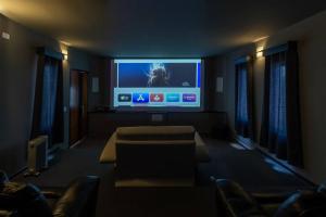 um quarto com uma televisão de ecrã plano e sofás em Cine-Lux Villa em La Concepción