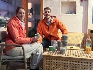 a man and a woman sitting at a table at Wally House青山惠风民宿 in Zhangjiajie