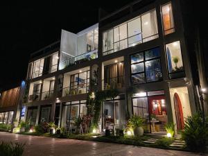 a large building with many windows at night at Palassa Private Residences in Boracay