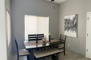 a dining room with a wooden table and chairs at Havasu Retreat! Pool, Spa, Gym & View in Lake Havasu City