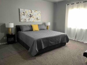a bedroom with a bed and two lamps and a window at Havasu Retreat! Pool, Spa, Gym & View in Lake Havasu City