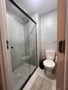 a bathroom with a toilet and a glass shower at Novinho Allianz Parque in Sao Paulo