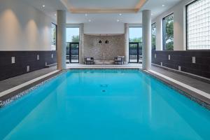 a swimming pool with blue water in a building at Delta Hotels by Marriott Toronto Markham in Markham