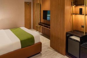 A bed or beds in a room at Ironwood Hotel