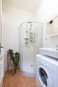 a bathroom with a shower and a washing machine at Prague city centre in Prague