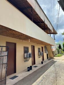 a building with three air conditioning units on the side at Alona Bohol Backpackers Hostel in Panglao