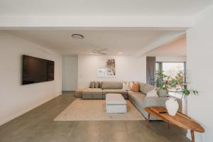 a living room with a couch and a tv at Quail Cove in Gold Coast