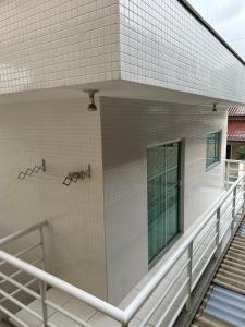 a balcony of a building with a bench on it at Residencial Lara in Itapema