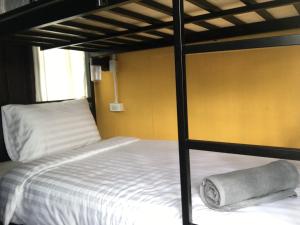 a bedroom with a bunk bed with a towel on it at Imchai in Pai
