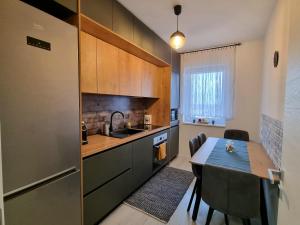 a kitchen with a table and a dining room at Ana&Patrick FriendlyApartment in Oradea