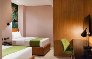 A bed or beds in a room at Ironwood Hotel