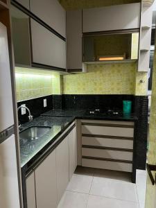 里約熱內盧的住宿－Solar Del Passo，厨房配有白色橱柜和水槽