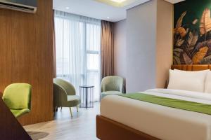 A bed or beds in a room at Ironwood Hotel