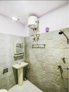 a bathroom with a sink and a shower at OYO 81146 Hotel Prashant Villa in Gwalior