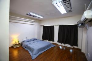ein Schlafzimmer mit einem Bett in der Mitte eines Zimmers in der Unterkunft Private GameRoom and Cinema at The CEO Penang in Bayan Lepas