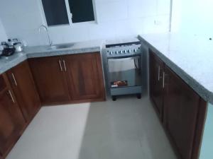 a kitchen with a stove and a counter top at Casa de playa Briceño// Beach house Briceño in Briseño