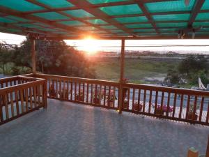 a view of the sunset from the deck of a house at Casa de playa Briceño// Beach house Briceño in Briseño