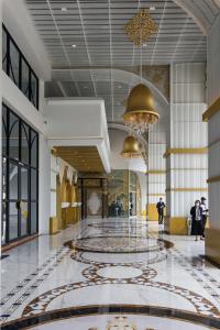 a lobby with a marble floor and a chandelier at Arena Gaming Suite In Arte Mont Kiara in Kuala Lumpur