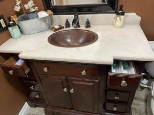 a bathroom counter with a sink and a mirror at Luxury Cozy Studio with Firepit in Vista