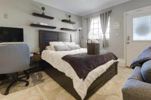 a bedroom with a bed and a desk and a television at Luxury Cozy Studio with Firepit in Vista