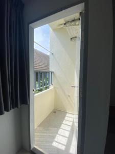 an open door to a room with a window at ศิวพฤกษ์ เพลส in Nonthaburi