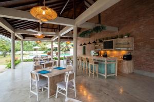 a kitchen and dining area with tables and chairs at The Jam House in Ahangama