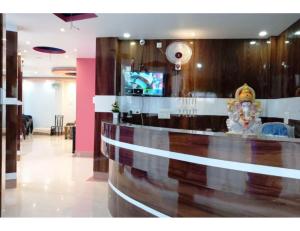 a lobby with a dance floor in a building at Hotel Invite, Agartala in Agartala