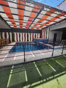 a swimming pool in a building with an open roof at Departamento con buena ubicación in Ciudad Juárez