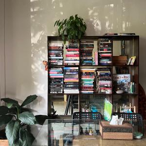 a book shelf filled with lots of books at Simple House Ao Nang - B&B in Krabi town