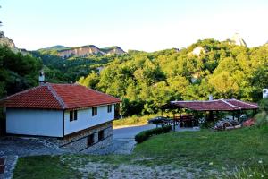 a house and a gazebo next to a road at Melnik Pyramids Guesthouse in Zlatkov Chiflik