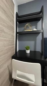 a black table with a plant on a shelf at Golden Gate Park Sweet Home-2 bedrooms in San Francisco