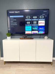 a white cabinet with a tv on top of it at Golden Gate Park Sweet Home-2 bedrooms in San Francisco