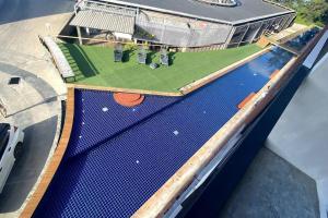 an overhead view of a tennis court with a artificial turf field at [NEW] Cozy Modern Studio with Pool & Gym in Koh Samui 