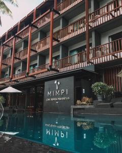 a building with a swimming pool in front of it at Mimpi Perhentian in Perhentian Islands