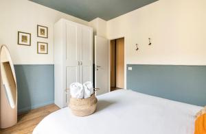 a bedroom with a bed with a basket on it at Ripa Apartments Milano - Vigevano in Milan