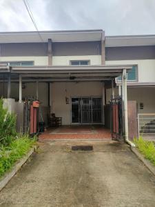 an outside view of a house with an open garage at Prima Homestay Ranau in Ranau
