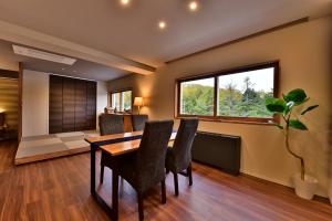 a dining room with a table and chairs at Shiga Grand Hotel in Yamanouchi