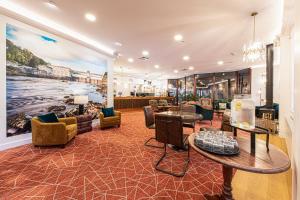 a living room with a large painting on the wall at Scotland's Spa Hotel in Pitlochry