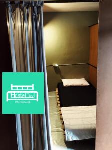 two bunk beds in a room with a sign that reads hosteladj at HostelBed @ Phitsanulok in Phitsanulok