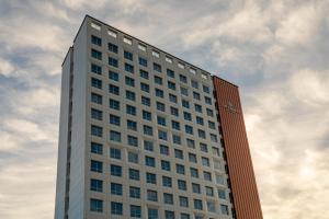 a tall white building with a sky in the background at Radiant Nampo Hotel in Busan