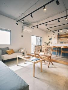 a living room with two chairs and a table at intro vetta 1002 Free Private sauna in Kumamoto