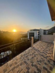 a view of the sunset from the balcony of a building at KM Apartments in Kotor