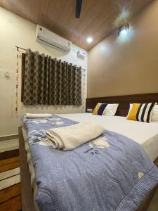 Postel nebo postele na pokoji v ubytování Tattva Paying guesthouse