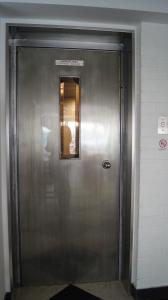 a metal elevator in a building with a window at Hotel Freiheit in Cologne