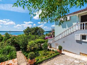 a view from the balcony of a house with a garden at Holiday Home Maslenica with Sea Views & Pool in Maslenica
