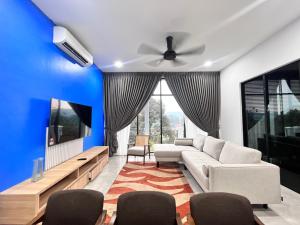 a living room with a couch and a ceiling fan at Jenderam Hill Villa in Sepang