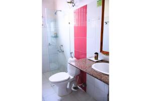 a bathroom with a toilet and a sink at FabEscape Orient Royal in Calangute