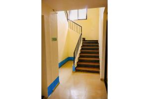 a hallway with stairs in a building at FabEscape Orient Royal in Calangute